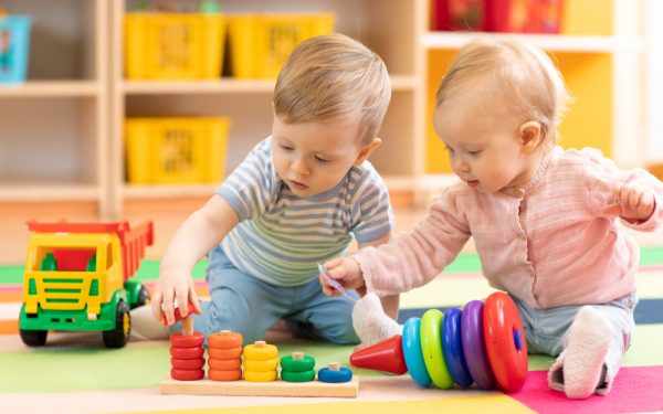 Preschool,Boy,And,Girl,Playing,On,Floor,With,Educational,Toys.