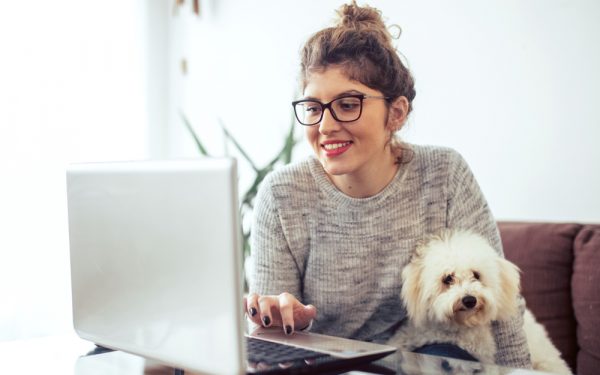 Young,Woman,Working,At,Home.,She,Is,With,Her,Dogs