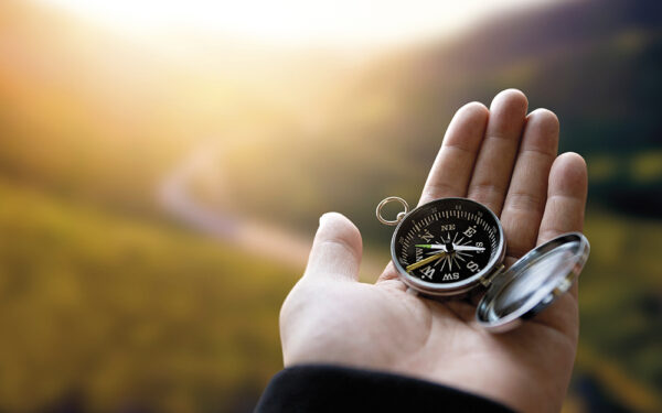 Traveler,Explorer,Man,Holding,Compass,In,A,Hand,In,Mountains