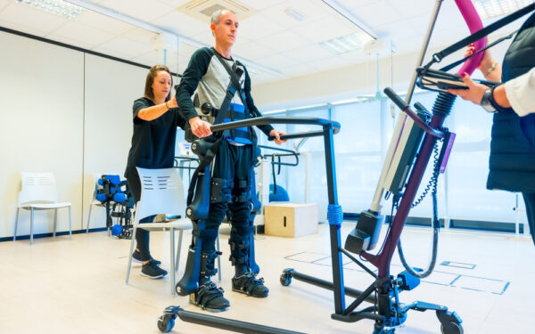 Mechanical,Exoskeleton.,Female,Physiotherapy,Medical,Assistant,Lifting,Man,With,A